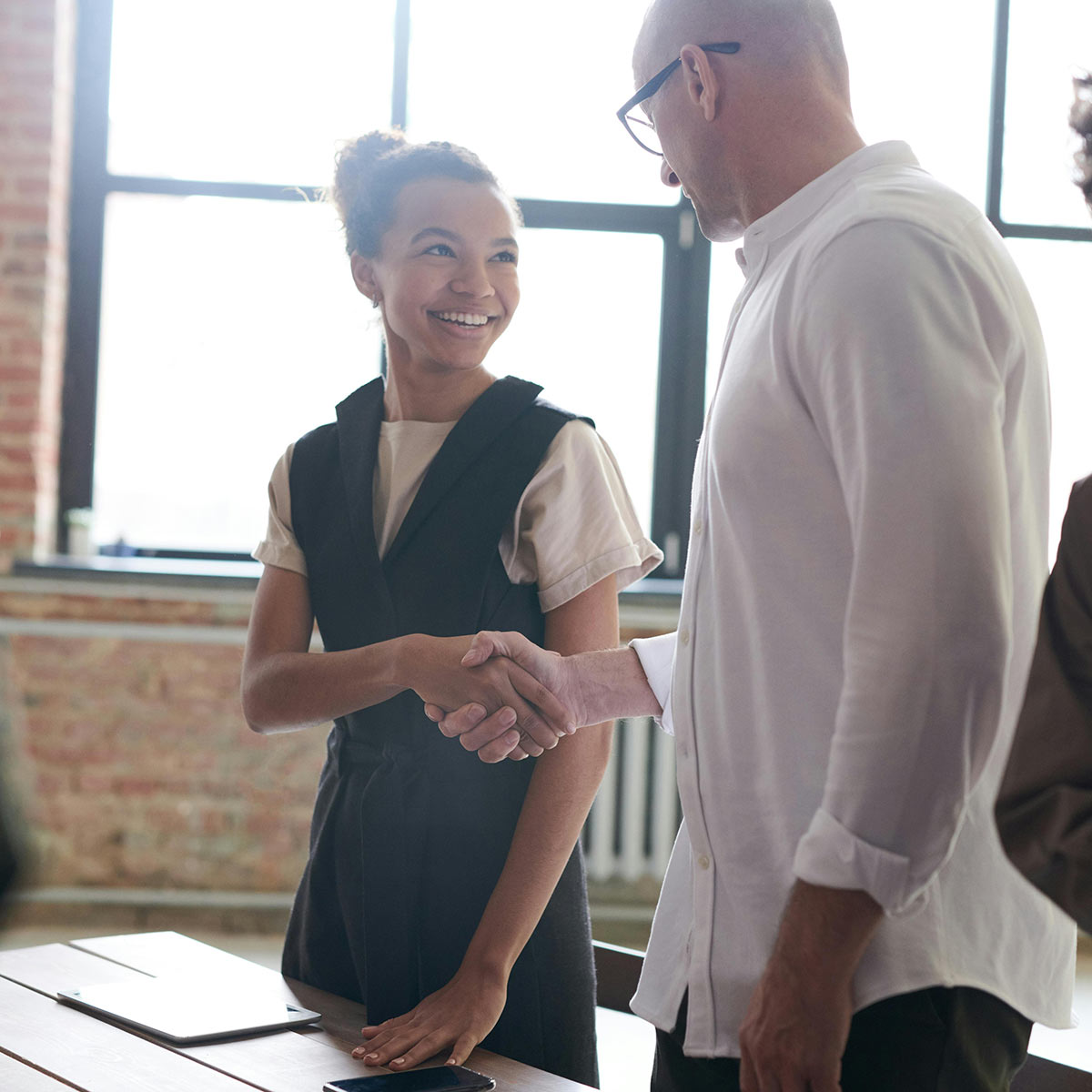 Two individuals shaking hands